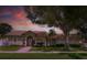 Inviting home exterior with a well-maintained lawn, mature trees, and a tile roof at 12470 93Rd St, Largo, FL 33773