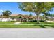 Charming single-story home with a well-maintained lawn and a large shade tree in the front yard at 12470 93Rd St, Largo, FL 33773
