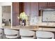 Close-up of the kitchen island highlighting the granite countertop, barstool seating, and decorative details at 12470 93Rd St, Largo, FL 33773