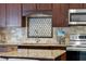 The kitchen features granite countertops, tile backsplash, stainless steel appliances, and a stylish faucet at 12470 93Rd St, Largo, FL 33773