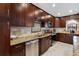 Well-designed kitchen with stainless steel appliances, granite countertops, custom cabinetry, and tile backsplash at 12470 93Rd St, Largo, FL 33773