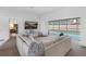 Bright living room with white sofas and a seamless transition to the pool area at 12470 93Rd St, Largo, FL 33773