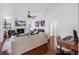 Bright living room with a fireplace, comfortable sofas, and a view towards an adjacent office space at 12470 93Rd St, Largo, FL 33773