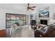 Inviting living room with a cozy fireplace, comfortable seating, and sliding doors leading to a screened patio and pool at 12470 93Rd St, Largo, FL 33773