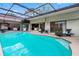 Enclosed in-ground swimming pool with plenty of outdoor lounge space for relaxing and fun at 12470 93Rd St, Largo, FL 33773
