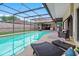Beautiful screened-in pool area with outdoor kitchen and lounge area, perfect for entertaining at 12470 93Rd St, Largo, FL 33773