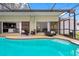 Enchanting pool area featuring outdoor seating, seamless access to interior spaces, and outdoor tranquility at 12470 93Rd St, Largo, FL 33773