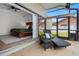 Relaxing screened patio with a lounge chair, side table, and a view into the main bedroom at 12470 93Rd St, Largo, FL 33773