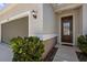 Close-up of the home's exterior showing the garage door and front entrance at 12697 Achasta Blvd, Hudson, FL 34669