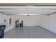 Clean and spacious two car garage with white painted walls and epoxy floor at 12697 Achasta Blvd, Hudson, FL 34669