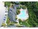 Overhead view showcasing the pool area with nearby apartments and landscaping at 13235 Sanctuary Cove Dr # 201, Temple Terrace, FL 33637