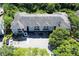 Aerial view showcasing the apartment building nestled in a lush, green environment with ample parking at 13235 Sanctuary Cove Dr # 201, Temple Terrace, FL 33637