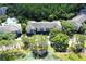 Aerial view highlighting apartment buildings surrounded by trees with a pond nearby at 13235 Sanctuary Cove Dr # 201, Temple Terrace, FL 33637