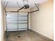 Garage featuring a standard door, an automatic door opener, and concrete floor at 13235 Sanctuary Cove Dr # 201, Temple Terrace, FL 33637