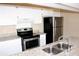 The kitchen features white cabinets, granite countertops, and stainless steel appliances at 13235 Sanctuary Cove Dr # 201, Temple Terrace, FL 33637