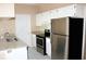 Bright kitchen featuring stainless steel appliances, ample cabinet space, and granite countertops at 13235 Sanctuary Cove Dr # 201, Temple Terrace, FL 33637