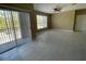 Bright living room featuring tile floors, ceiling fan, and sliding glass door to the outside balcony at 13235 Sanctuary Cove Dr # 201, Temple Terrace, FL 33637