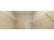 Empty walk-in closet with a wire shelf on each side. Ready for organization and storage at 13235 Sanctuary Cove Dr # 201, Temple Terrace, FL 33637