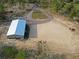 Drone shot showcasing the expansive property with a metal building, driveways, and surrounding greenery at 13268 Harrison St, Brooksville, FL 34613