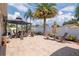 Backyard with a paver patio featuring a pergola covered table and chairs at 14711 Potterton Cir, Hudson, FL 34667