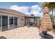 Spacious paver patio with an outdoor seating area and lush, tropical landscaping at 14711 Potterton Cir, Hudson, FL 34667
