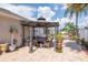 Large backyard paver patio featuring a pergola covered table and chairs at 14711 Potterton Cir, Hudson, FL 34667