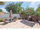 Paver patio with grill, pergola, chairs, and a well-maintained landscaped area at 14711 Potterton Cir, Hudson, FL 34667
