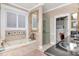 Elegant bathroom with a jetted tub, glass enclosed shower, and walk in closet at 14711 Potterton Cir, Hudson, FL 34667