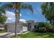 Charming single-Gathering home with manicured lawn, palm tree, and attached two-car garage at 14711 Potterton Cir, Hudson, FL 34667