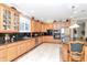 Well-appointed kitchen featuring custom cabinets, granite countertops, stainless appliances, and a central island at 14711 Potterton Cir, Hudson, FL 34667