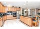 Spacious kitchen featuring custom cabinets, granite countertops, stainless appliances, and a central island at 14711 Potterton Cir, Hudson, FL 34667