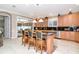 Well-appointed kitchen with wood cabinetry, breakfast bar, and stainless-steel appliances at 14711 Potterton Cir, Hudson, FL 34667