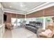 Relaxing sunroom with ample seating, neutral colors, and natural light at 14711 Potterton Cir, Hudson, FL 34667