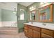 Bathroom featuring a double sink vanity, soaking tub, and tiled flooring at 15108 Springview St, Tampa, FL 33624