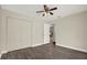 Bright bedroom with wood-look floors, ceiling fan, and closet at 15108 Springview St, Tampa, FL 33624