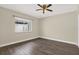 Bedroom featuring a ceiling fan, wood-look flooring, and natural light at 15108 Springview St, Tampa, FL 33624
