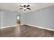 Spacious bedroom with modern flooring, neutral paint, a ceiling fan, and an en-suite bathroom entrance at 15108 Springview St, Tampa, FL 33624