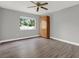 Bedroom with gray walls, wood look floors, ceiling fan and window for natural light at 15108 Springview St, Tampa, FL 33624