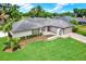 Charming single-story home features meticulously landscaped front yard, brick driveway, and attached garage at 15108 Springview St, Tampa, FL 33624
