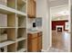 Hallway view with built in shelves leading to the living room with a fireplace at 15108 Springview St, Tampa, FL 33624