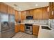 Well-lit kitchen with stainless steel appliances, wood cabinetry, and light countertops for cooking and entertaining at 15108 Springview St, Tampa, FL 33624