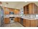 Well-equipped kitchen featuring stainless steel appliances, wood cabinets, and bright countertops for cooking at 15108 Springview St, Tampa, FL 33624