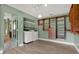 Spacious laundry room includes storage shelving, washer, and dryer at 15108 Springview St, Tampa, FL 33624