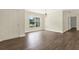 Bright living room features hardwood floors, large window, and white trim at 15108 Springview St, Tampa, FL 33624