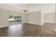 Living room with hard wood floors and sliding door to an enclosed lanai at 15108 Springview St, Tampa, FL 33624