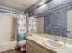 Bathroom with a shower-tub combo and decorative wallpaper at 1517 Gunsmith Dr, Lutz, FL 33559