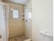 Clean tiled shower with built-in shelves and a window, paired with a white toilet at 1517 Gunsmith Dr, Lutz, FL 33559