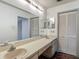 Bright bathroom featuring a long vanity with dual sinks and ample storage, next to a closet at 1517 Gunsmith Dr, Lutz, FL 33559
