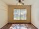 Bright bedroom features a ceiling fan, a large window, and wood-look floors at 1517 Gunsmith Dr, Lutz, FL 33559