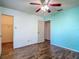 Bedroom with ceiling fan, laminate floors, and closet access at 1517 Gunsmith Dr, Lutz, FL 33559